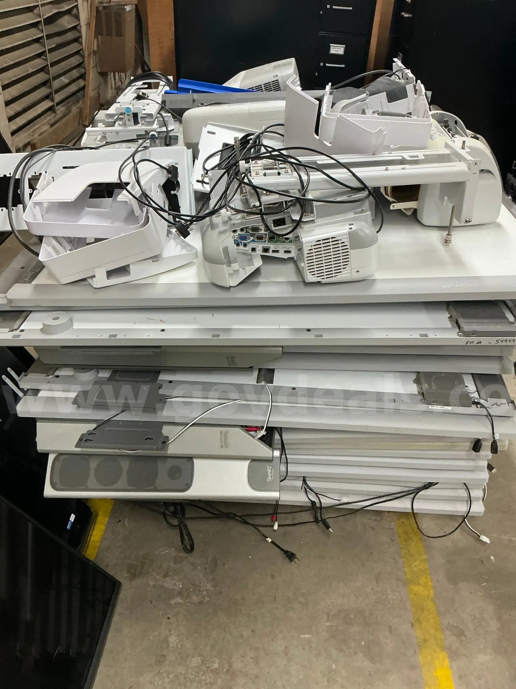 A pallet of smart boards and projectors