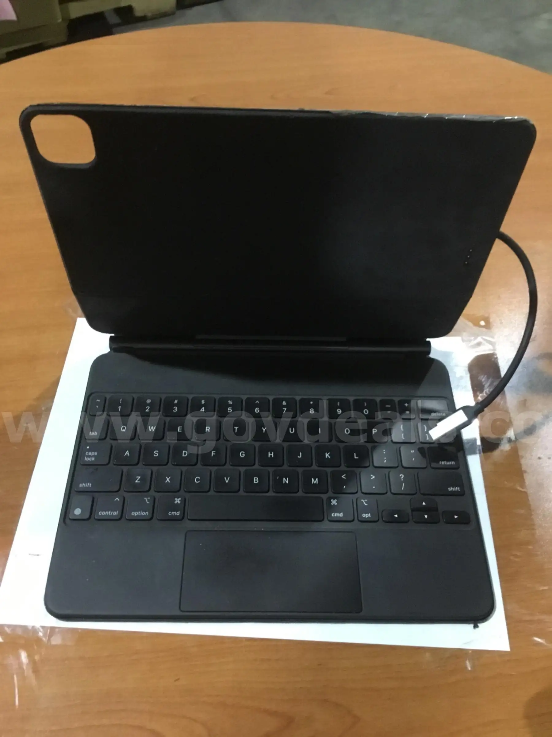 Black keyboard with an attached Oky electronic device “DH”