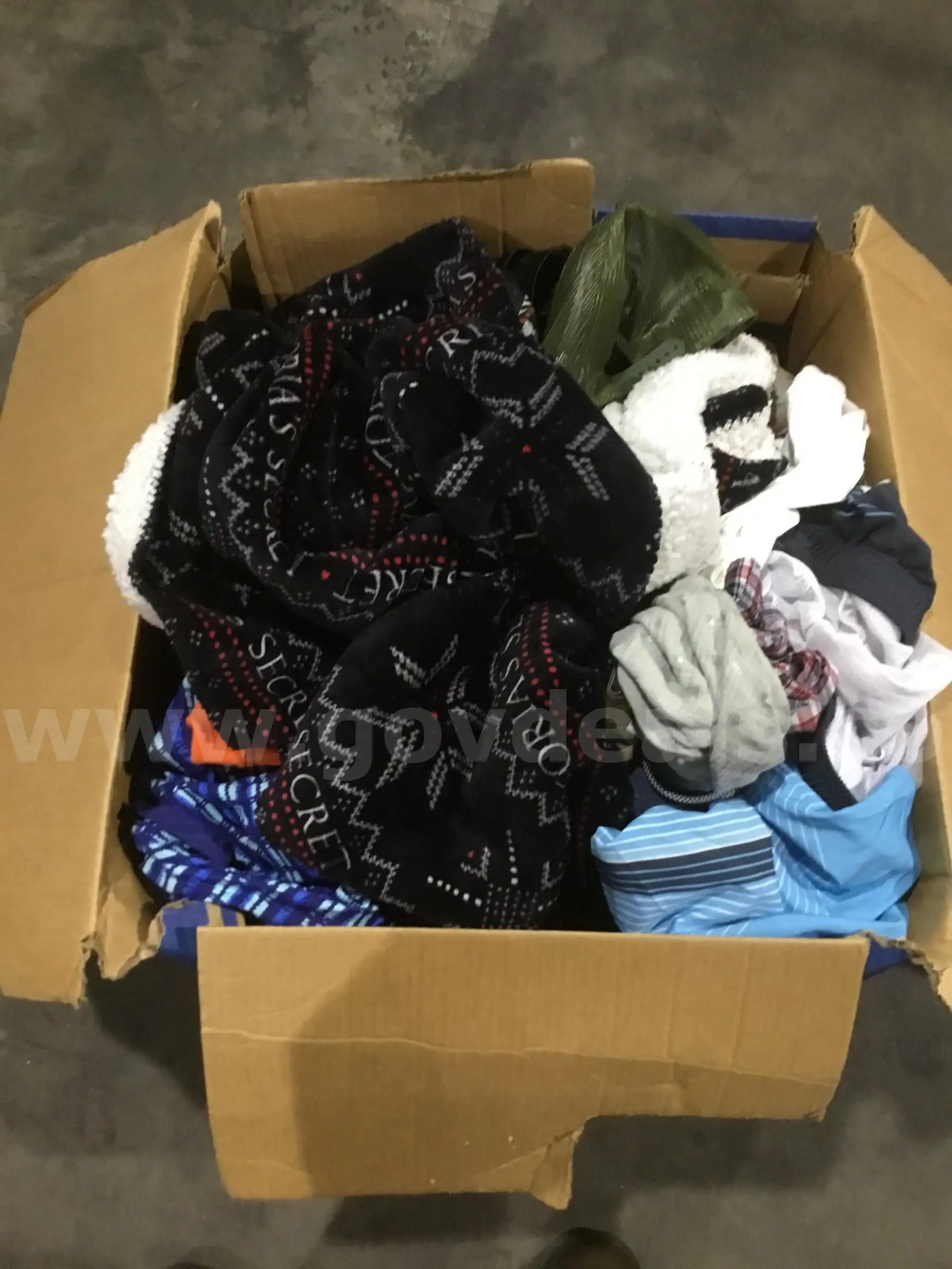 Box of clothes-shirts hats a rug DH