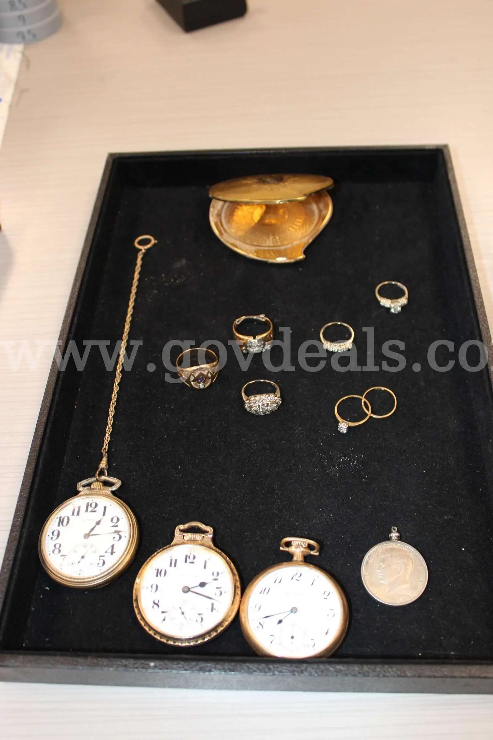 POCKET WATCH (3) RINGS (7) LOOSE STONE (1) CHARM WITH COIN (1) MIRROR (1)