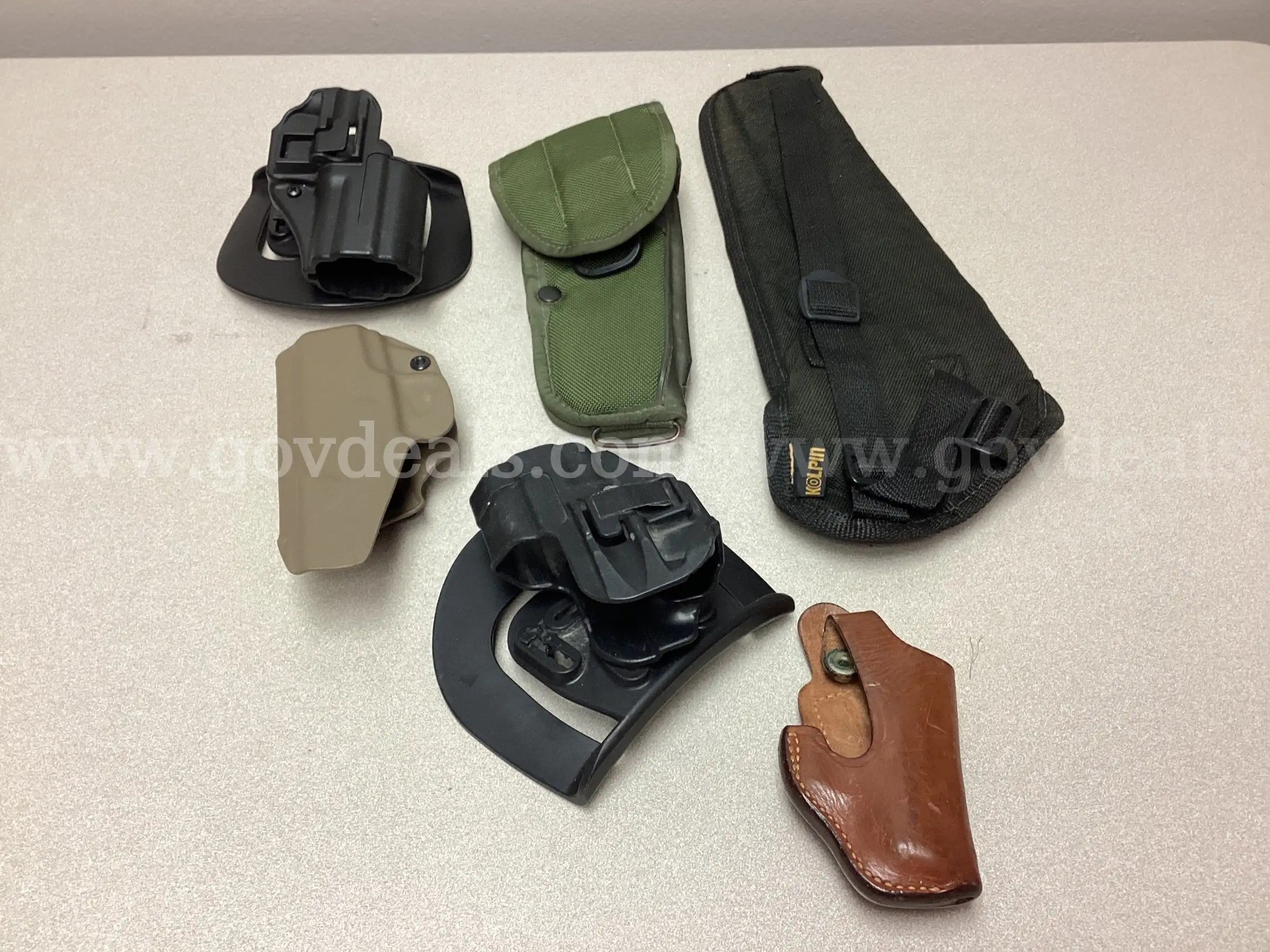 Assortment of Holsters Rifle Scopes Two Vintage Lead Bullets