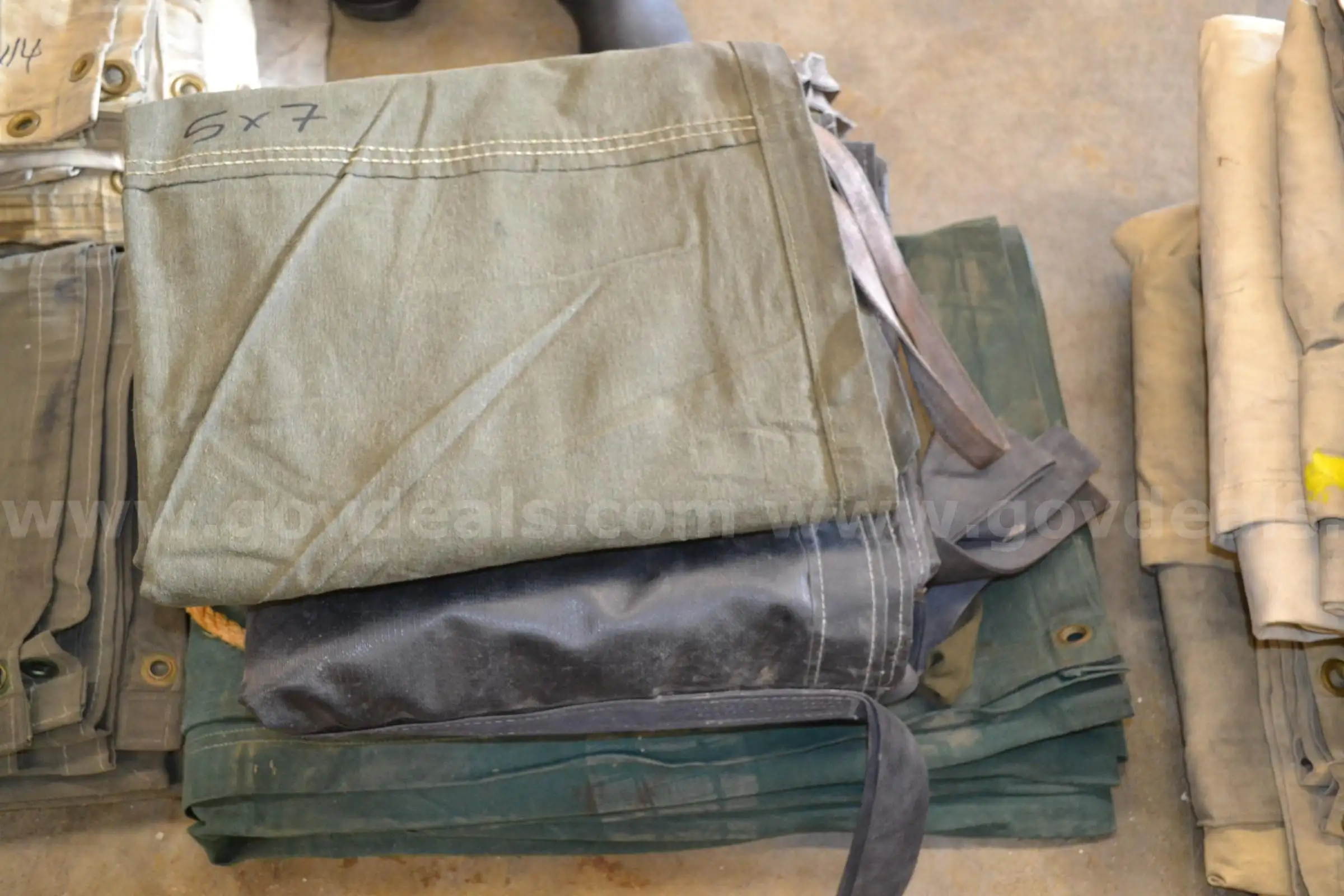 Lot to include Two (2) 11 x 16 canvas tarps Two (2) 5 x 5 canvas carryall tarps and One (1) 5 x 7 ca
