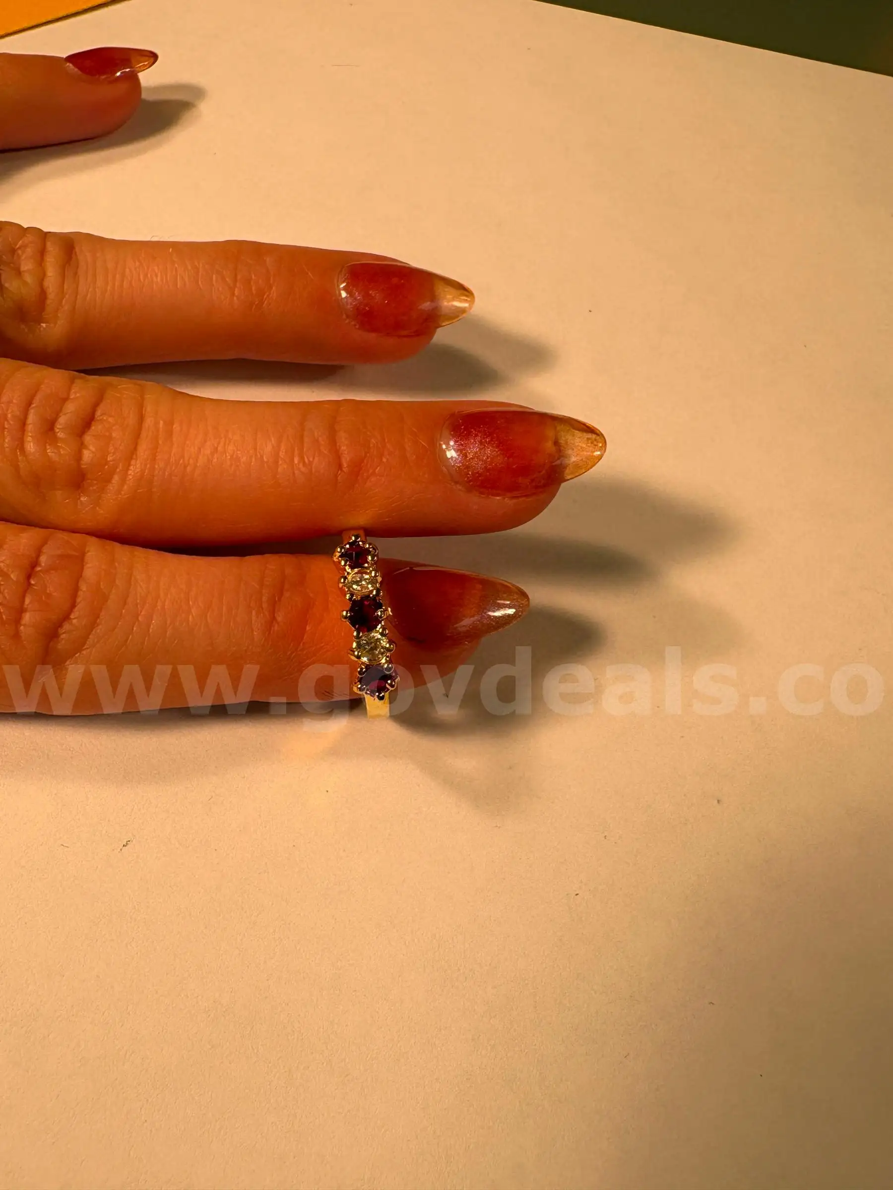yellow gold plated ring with fake red and clear stones