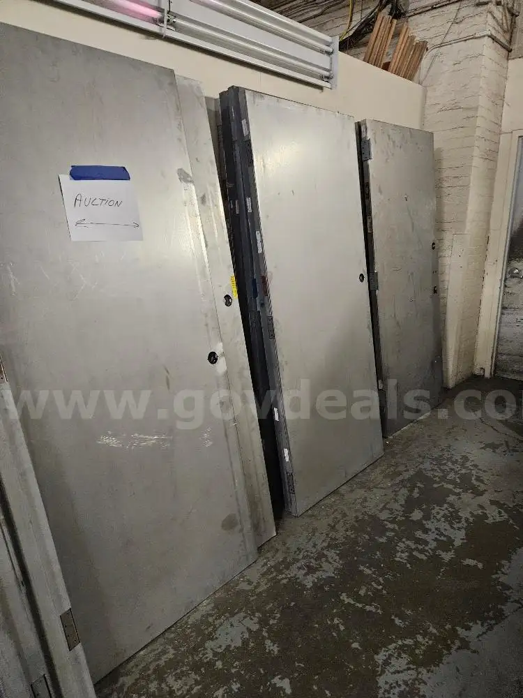 20 Metal Doors and 8 Stack of Metal Door Bucks. Sold As Is.