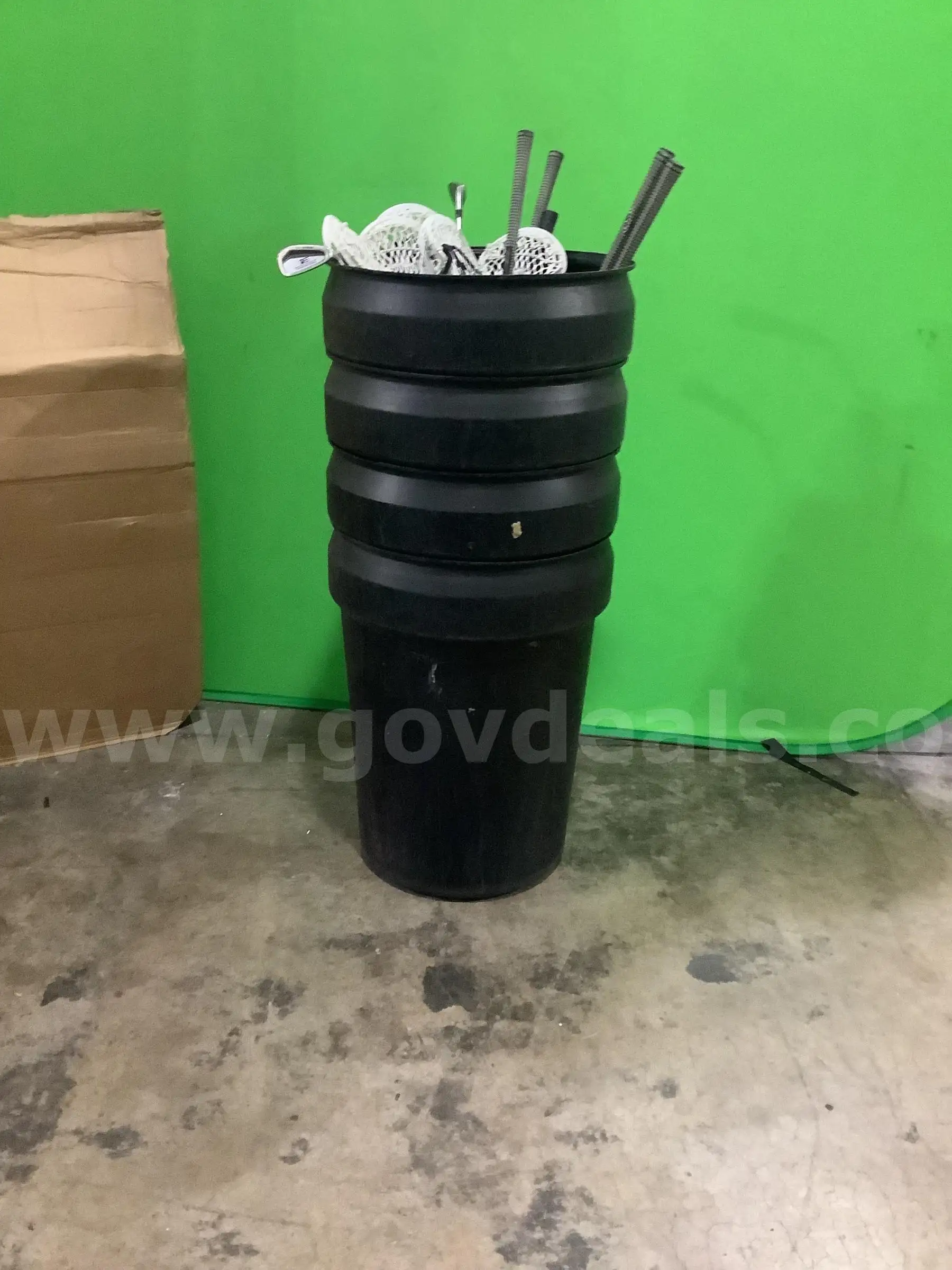 USED 4 TRASH CANS WITH MISCELLANEOUS SPORT EQUIPMENTS
