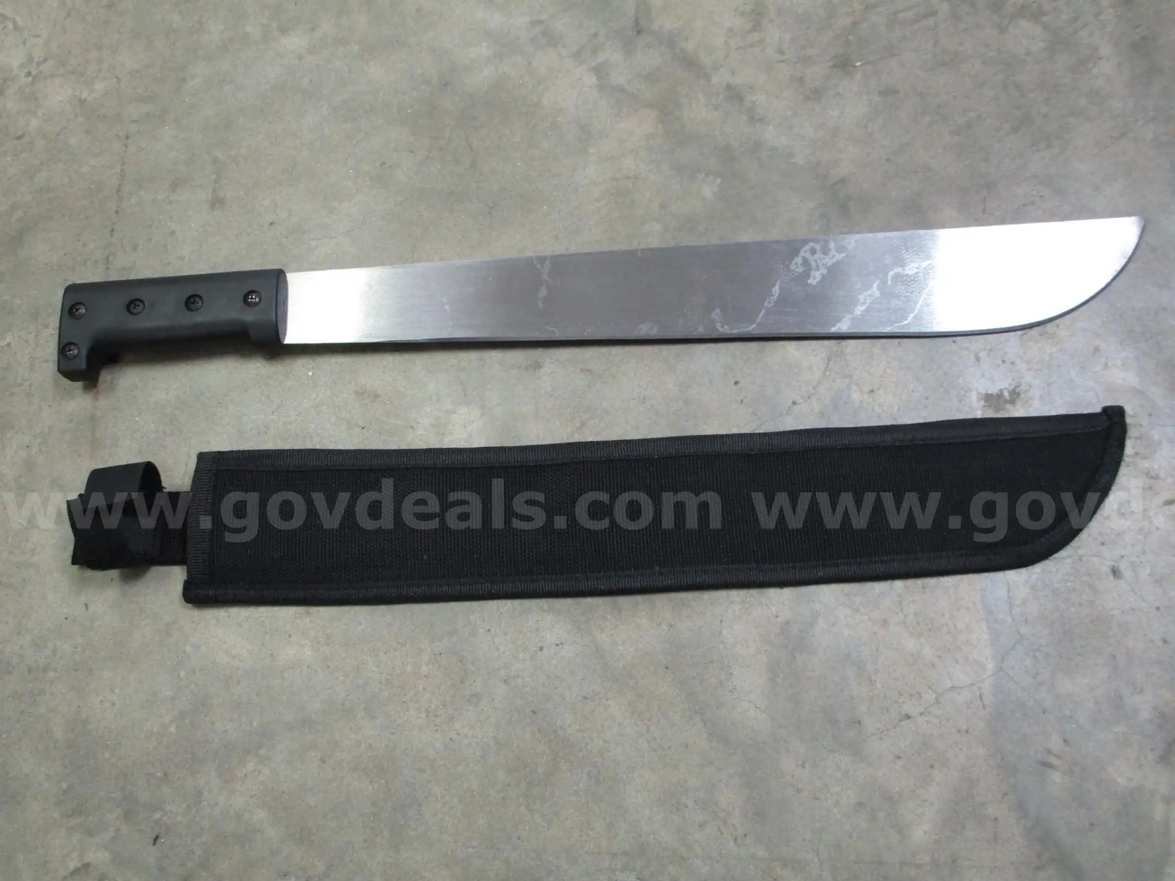 (1) USED MACHETE IN BLACK SHEATH
