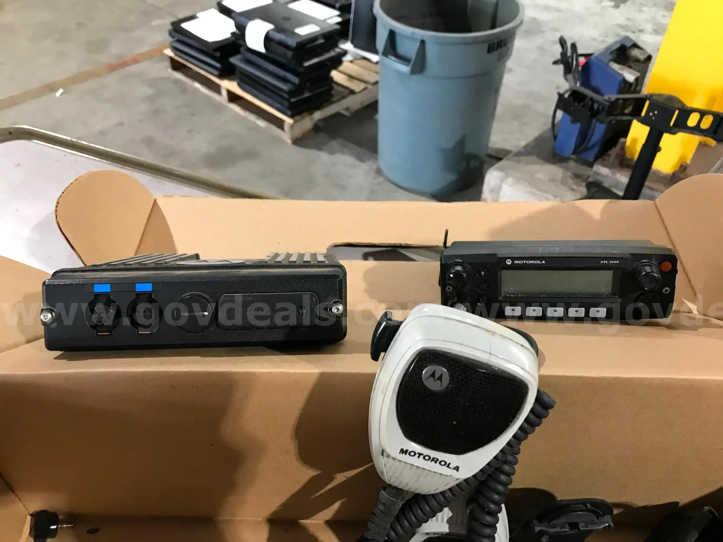 LOT OF MOTOROLA PORTABLE AND CAR RADIOS AND A SATELLITE PHONE ON ONE PALLET.
