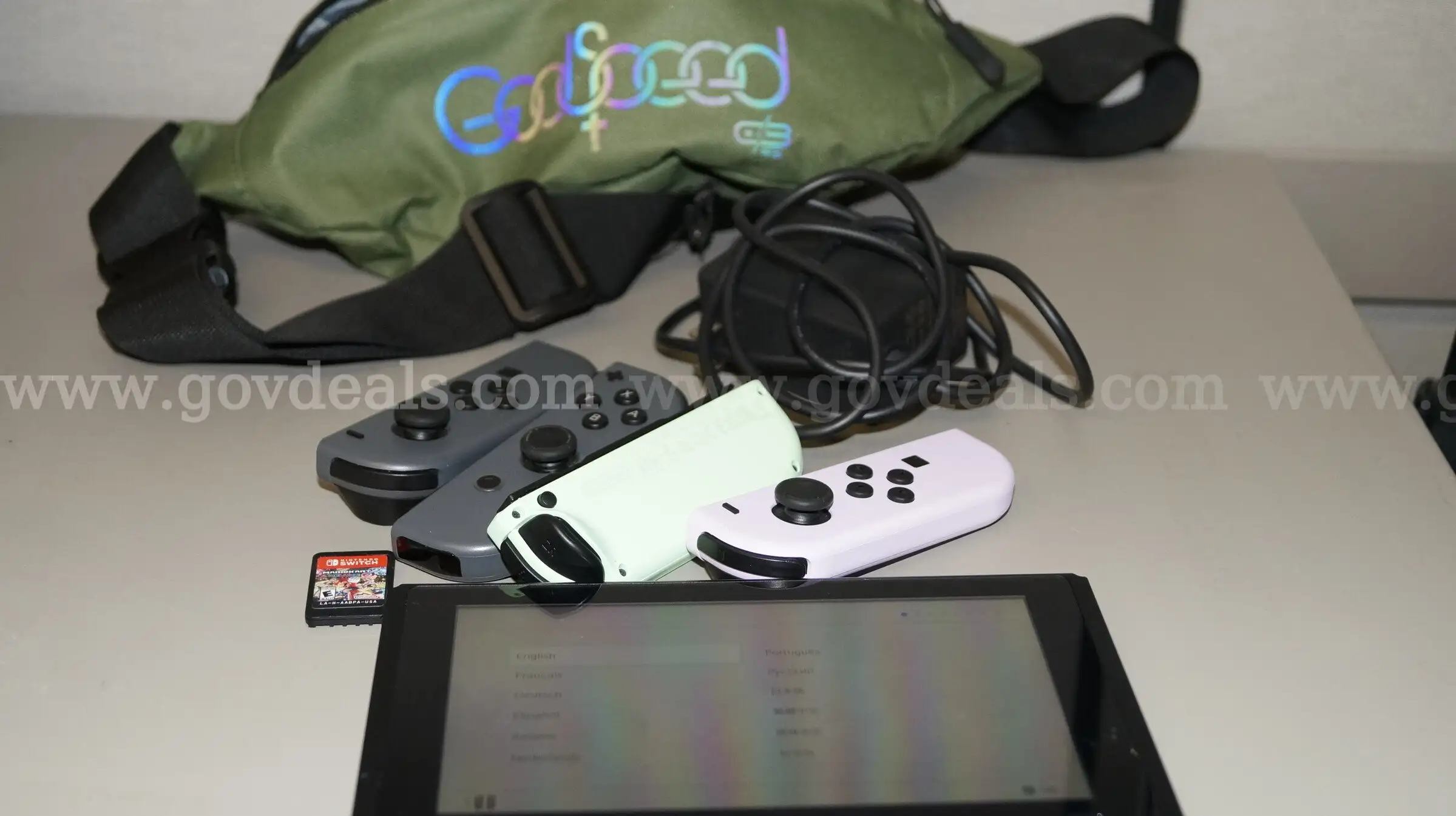 Nintendo Switch with 2 sets of controllers charger and fanny pack includes 1 game MarioKart